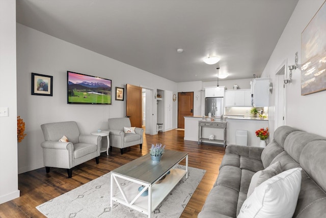 living room featuring dark wood-style floors and baseboards