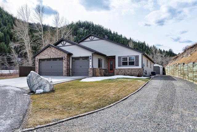 view of front of property with fence, concrete driveway, a front lawn, a garage, and brick siding