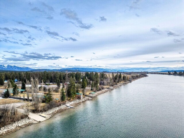 drone / aerial view with a water and mountain view