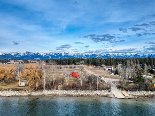 drone / aerial view with a water and mountain view