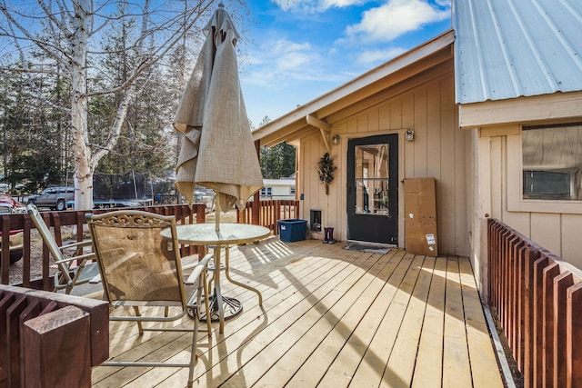 wooden deck featuring a trampoline