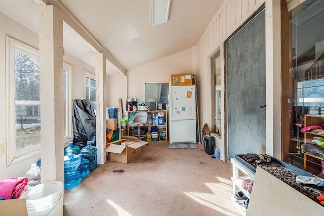 interior space featuring lofted ceiling and carpet floors