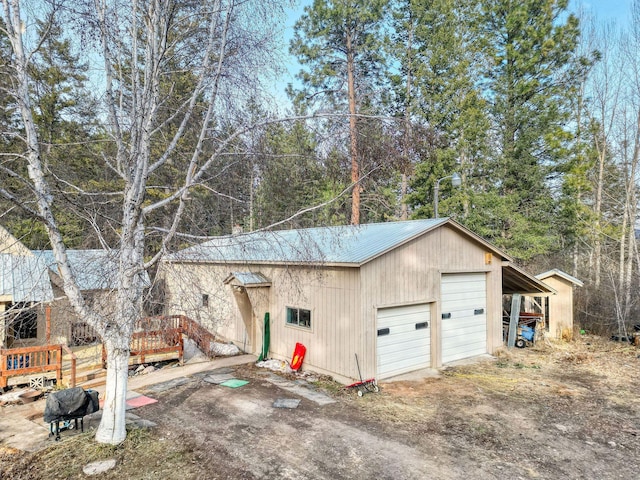 garage featuring a garage and dirt driveway