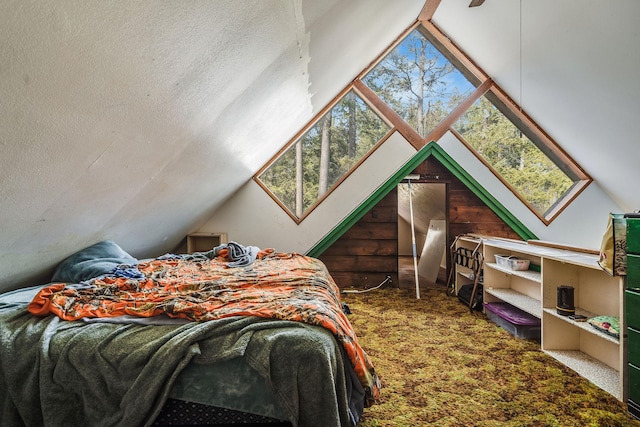 carpeted bedroom with lofted ceiling and a textured ceiling