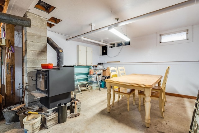 interior space featuring a wood stove and baseboards