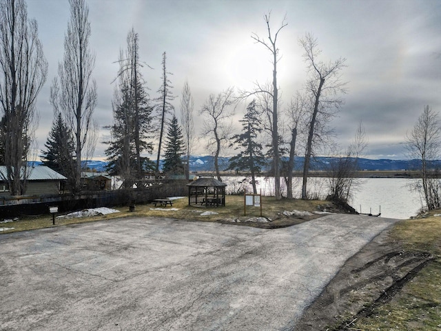 exterior space with a gazebo and a water and mountain view