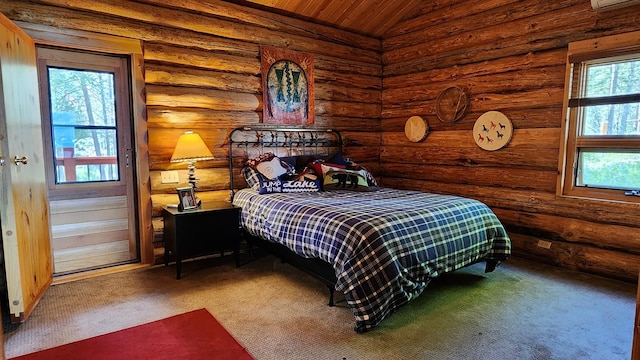 bedroom featuring vaulted ceiling, carpet floors, and log walls