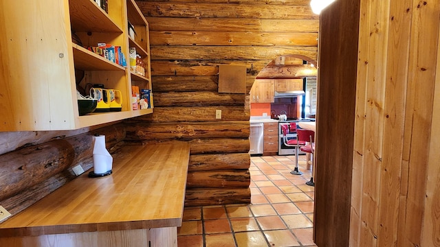 interior space with light tile patterned floors and rustic walls