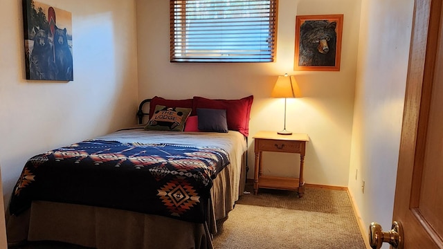 bedroom with baseboards and carpet