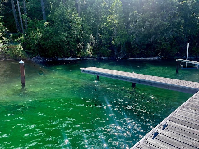 view of dock featuring a forest view