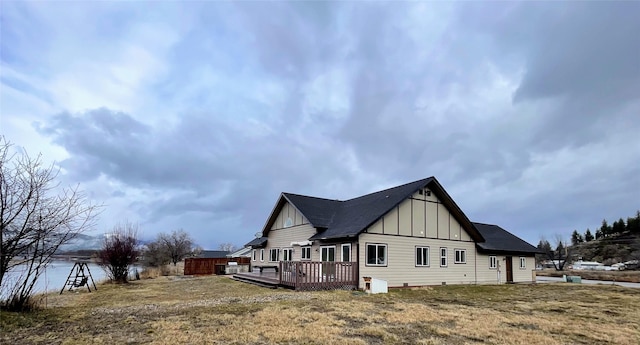 view of property exterior with a deck and board and batten siding