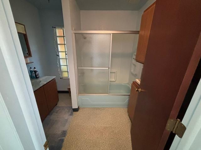 bathroom with vanity, toilet, and bath / shower combo with glass door