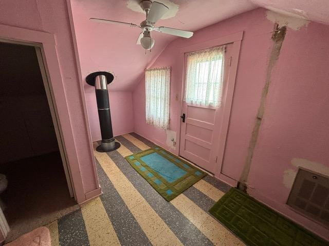 entrance foyer with visible vents, lofted ceiling, and a ceiling fan