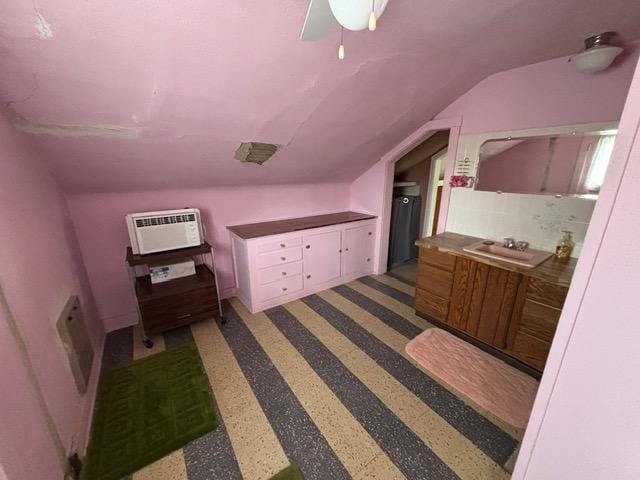 bonus room with lofted ceiling, a wall mounted air conditioner, and a sink