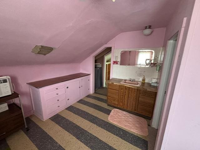 interior space with lofted ceiling and a sink