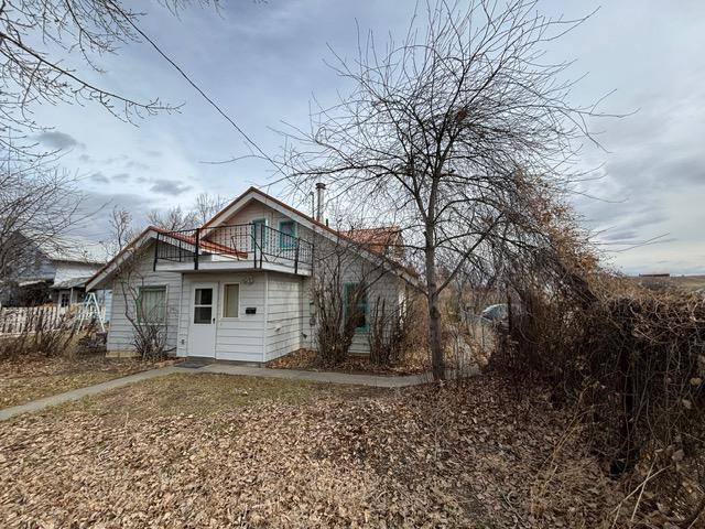 rear view of property with a balcony