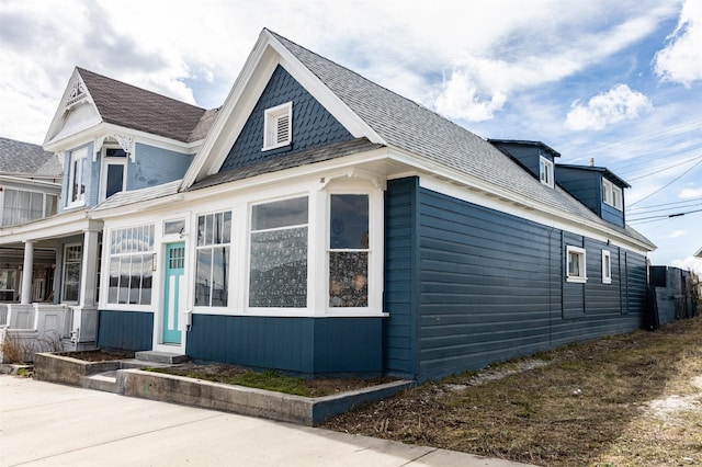 view of side of home featuring a shingled roof