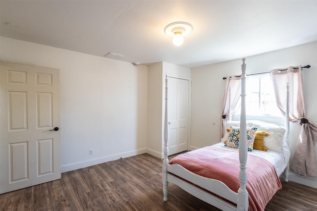 bedroom with baseboards and wood finished floors