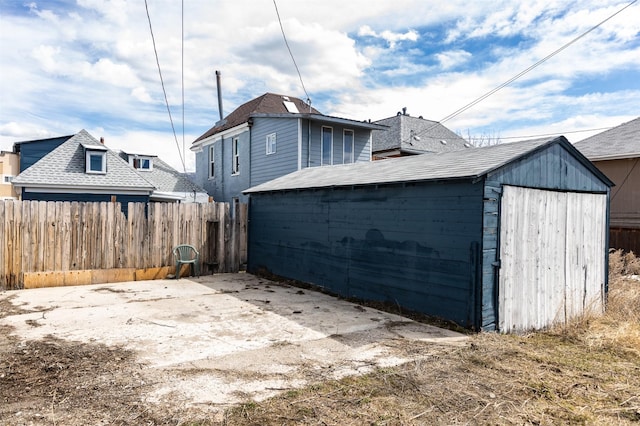 exterior space featuring an outbuilding and fence