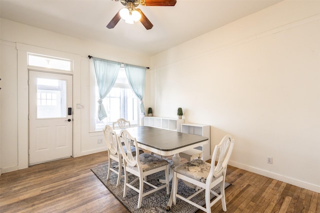 dining room with a ceiling fan, wood finished floors, and baseboards