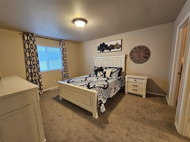 bedroom with baseboards and dark colored carpet