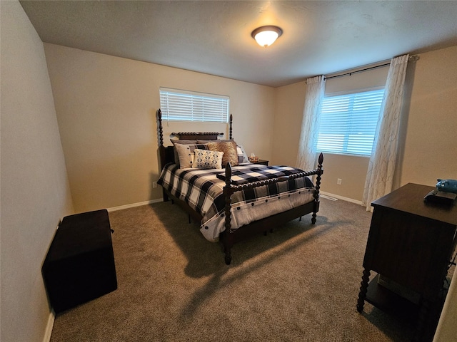 bedroom featuring baseboards and dark colored carpet