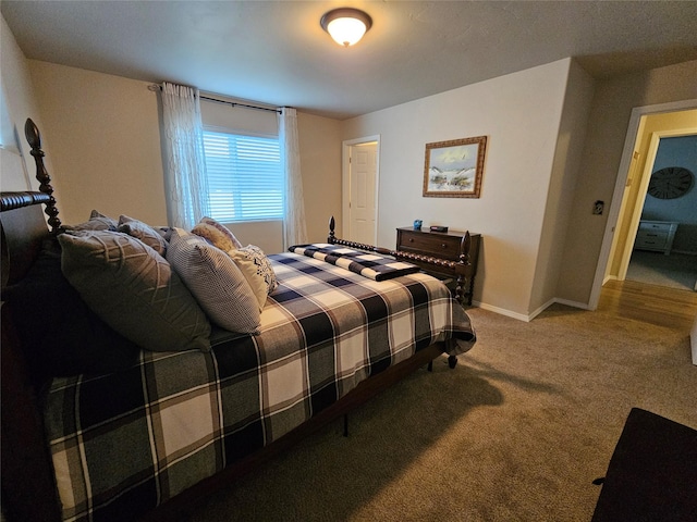 carpeted bedroom featuring baseboards