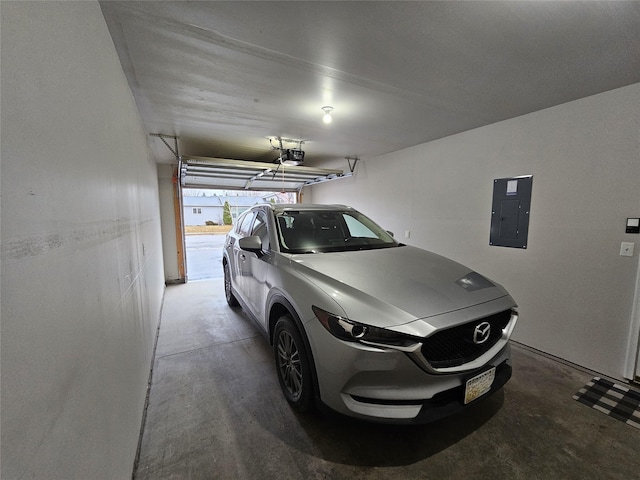 garage with electric panel and a garage door opener