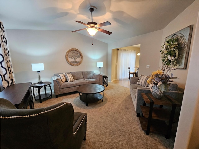 living room with carpet floors, ceiling fan, and vaulted ceiling