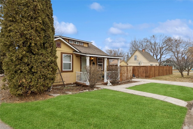 bungalow-style house with a front yard, fence, roof with shingles, a porch, and stucco siding