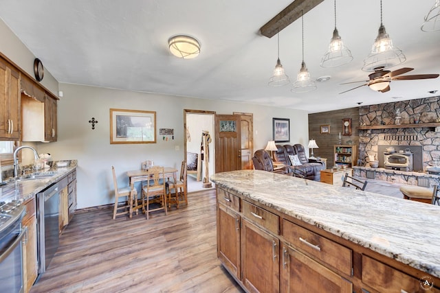 7415 Wildcat St, Helena, MT 59602 - kitchen featuring a sink, stainless steel appliances, a wood stove, and brown cabinets
