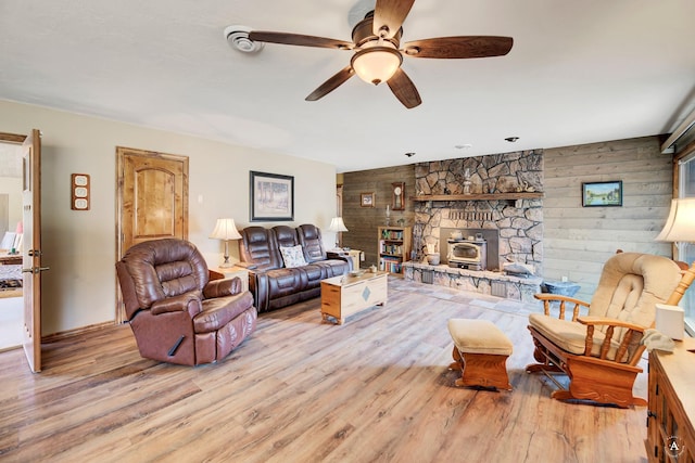 7415 Wildcat St, Helena, MT 59602 - living room featuring ceiling fan, a wood stove, and wood finished floors