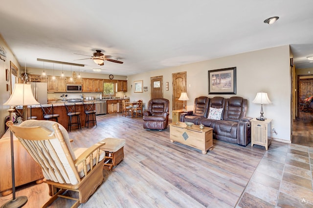 7415 Wildcat St, Helena, MT 59602 - living area featuring ceiling fan and light wood-style floors
