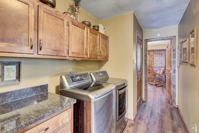 7415 Wildcat St, Helena, MT 59602 - washroom featuring cabinet space, separate washer and dryer, dark wood-type flooring, and baseboards