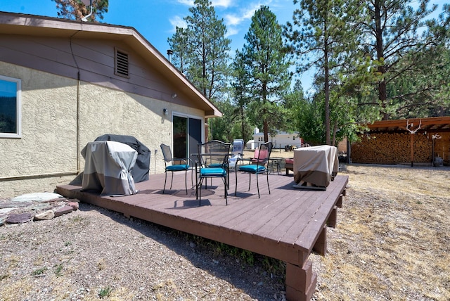 wooden terrace featuring a grill