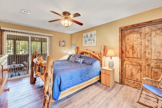 7415 Wildcat St, Helena, MT 59602 - bedroom with light wood-type flooring, a textured ceiling, and a ceiling fan