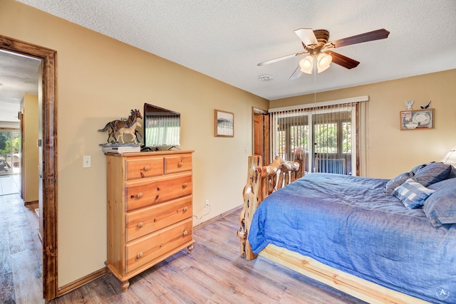 7415 Wildcat St, Helena, MT 59602 - bedroom with wood finished floors, multiple windows, a textured ceiling, ceiling fan, and access to exterior