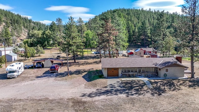 7415 Wildcat St, Helena, MT 59602 - aerial view of property and surrounding area featuring a heavily wooded area