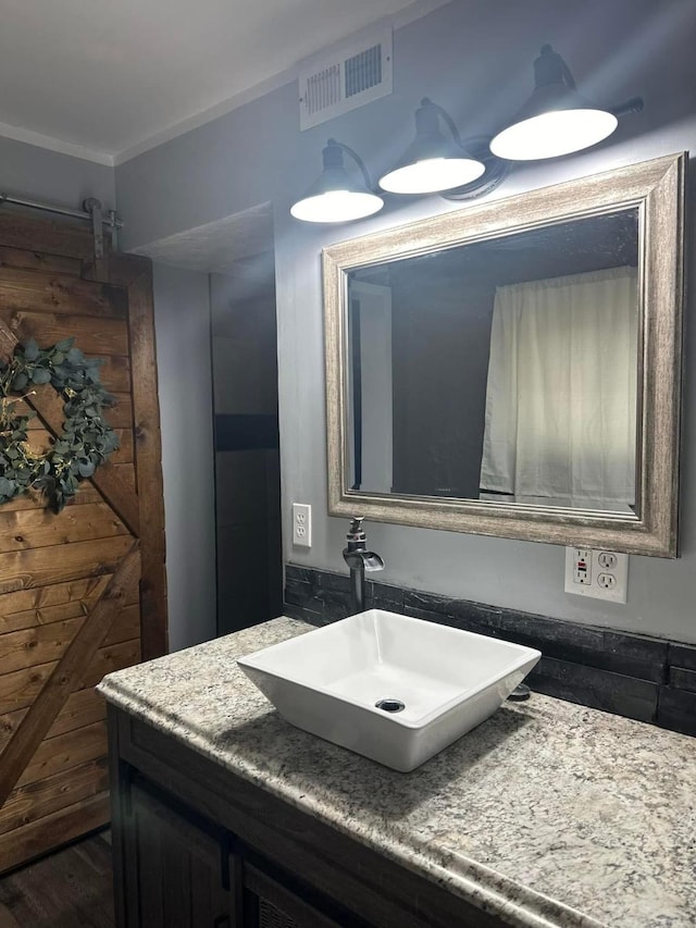 bathroom featuring vanity and visible vents