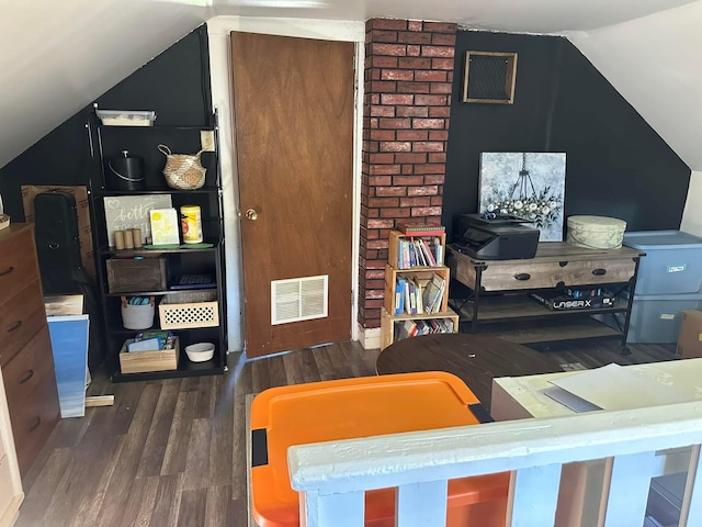 bedroom featuring vaulted ceiling, wood finished floors, and visible vents