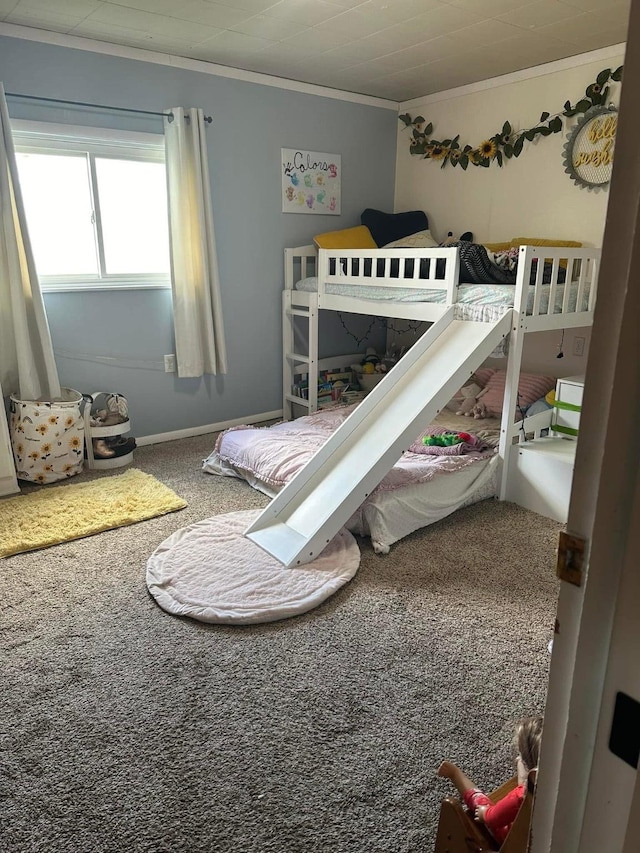 carpeted bedroom with crown molding and baseboards