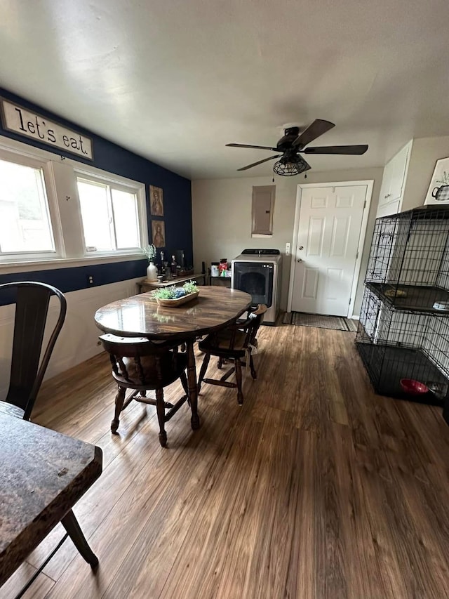 dining space with electric panel, wood finished floors, and ceiling fan