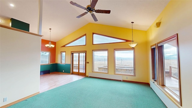 unfurnished living room with high vaulted ceiling, ceiling fan with notable chandelier, a baseboard heating unit, carpet floors, and baseboards