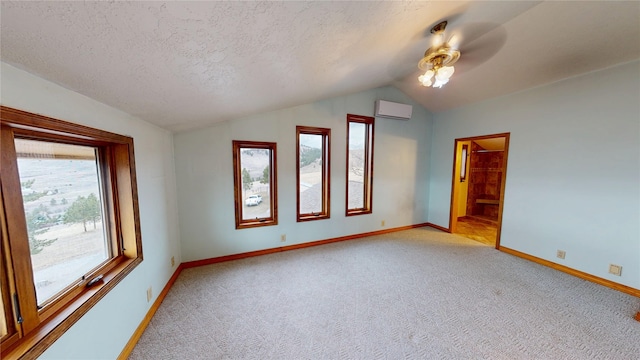 unfurnished room featuring light colored carpet, a wall mounted air conditioner, vaulted ceiling, a textured ceiling, and a ceiling fan