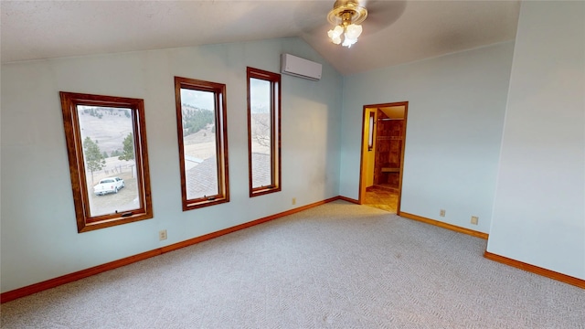 spare room with lofted ceiling, a wall mounted AC, carpet flooring, baseboards, and ceiling fan