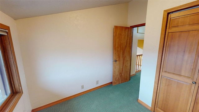 interior space with carpet and baseboards