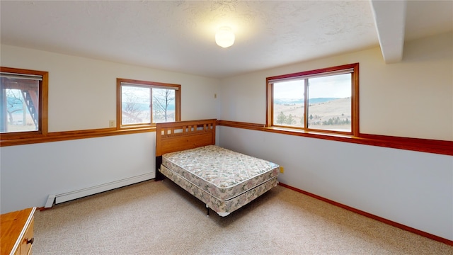 bedroom featuring baseboards, carpet floors, and a baseboard radiator