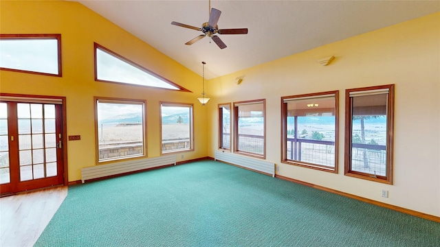 interior space with ceiling fan, vaulted ceiling, radiator, and a baseboard radiator