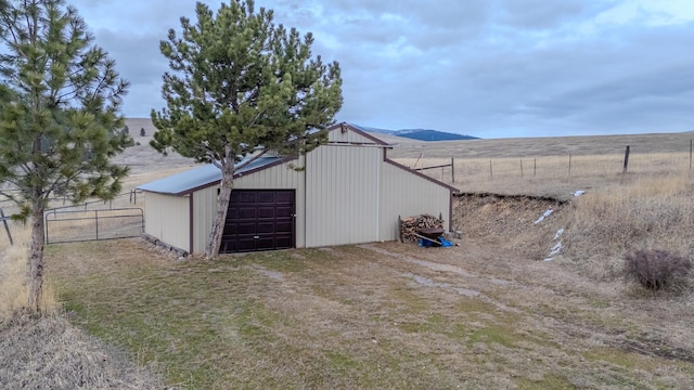 exterior space featuring fence, a garage, and driveway