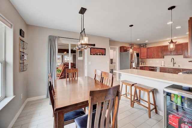 dining room with recessed lighting, baseboards, and beverage cooler